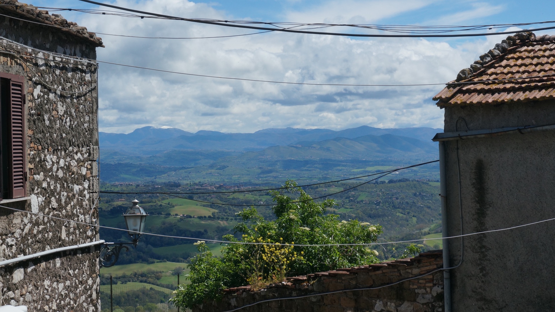 View of distant hills seen between two houses