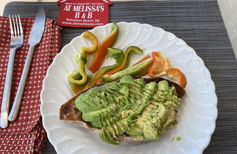 avocado smooshed on toasted flaxseed currant ciabatta