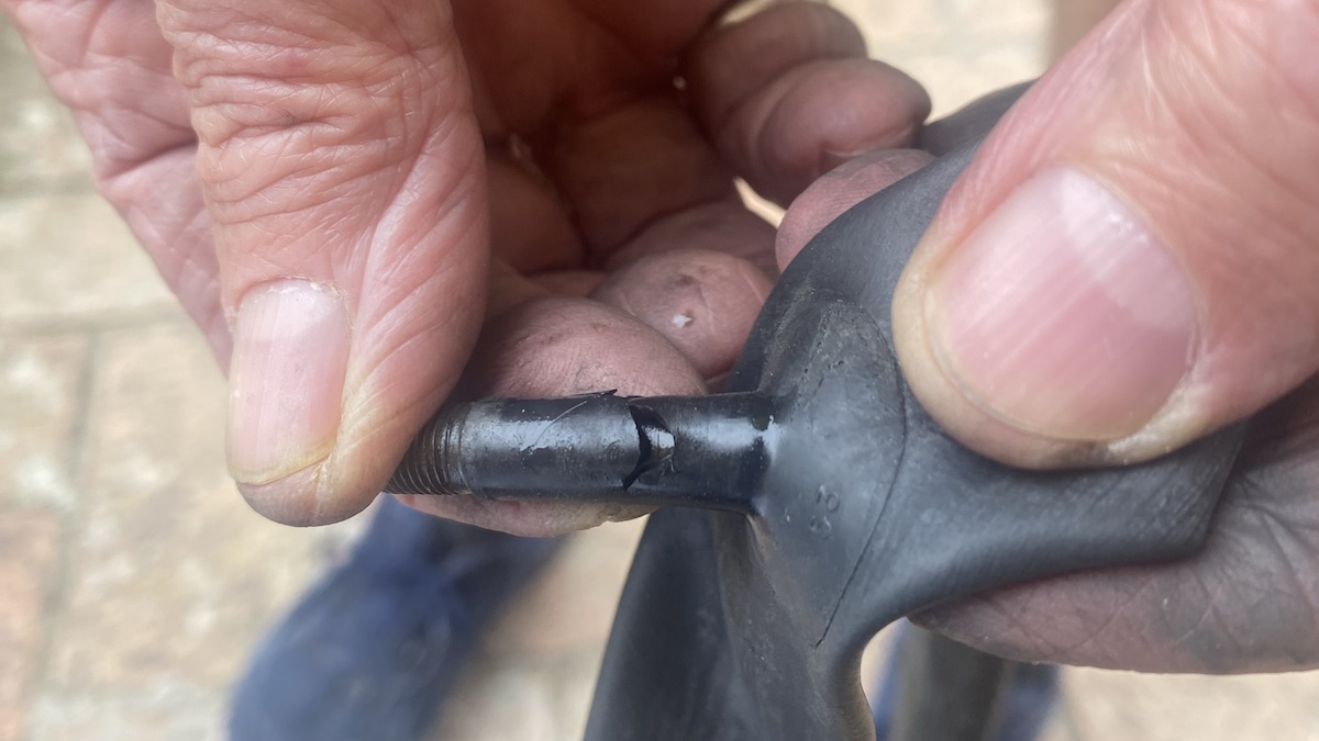 Large cracks in the stem of a Schrader bicycle valve