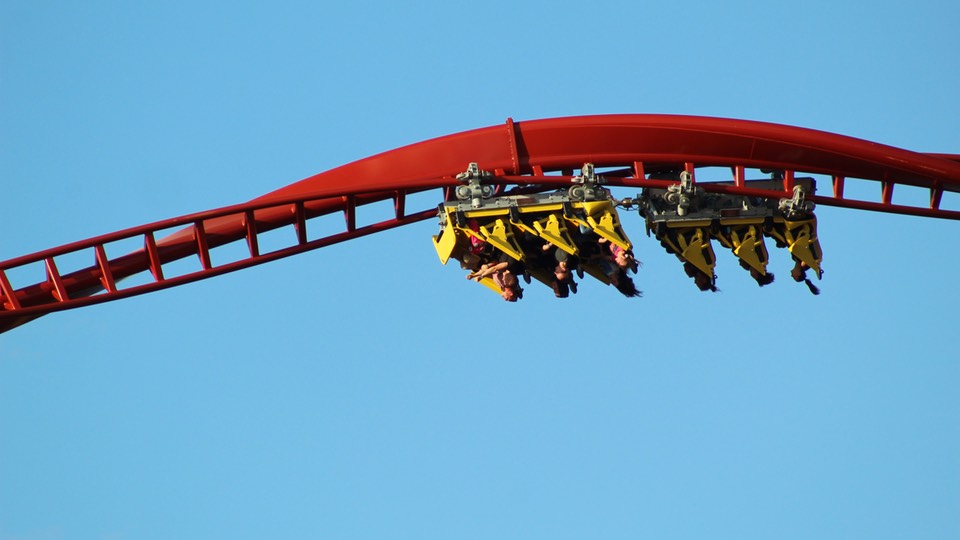 A roller-coast car upside down full of people